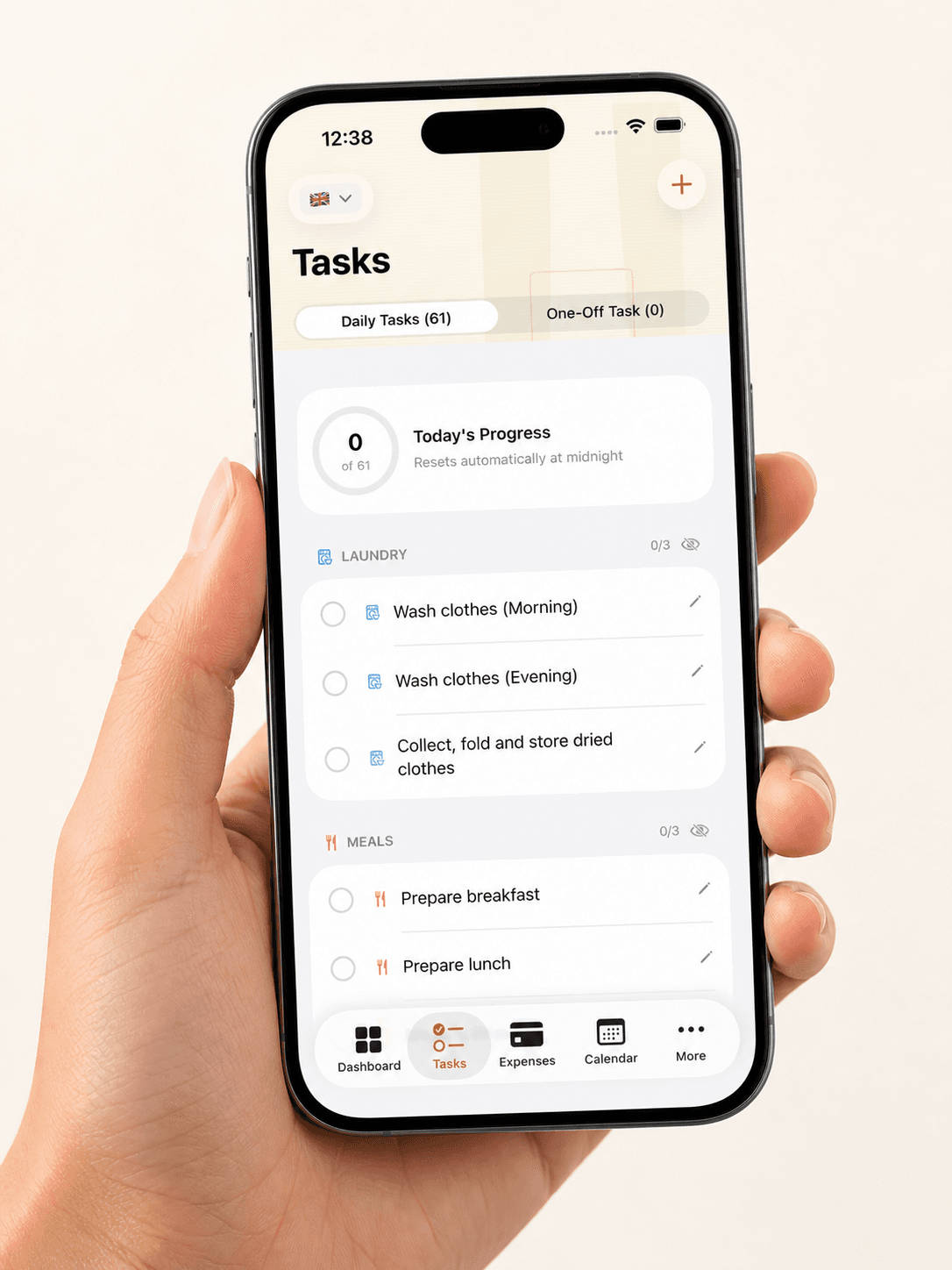 Hand holding a smartphone displaying a task management app with laundry and meal preparation tasks.